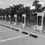 MURDERED While Charging Tesla — Killer Freed Hours Before Empty Tesla Supercharger stations in a parking lot.