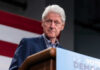 Bill Clinton speaking at podium.