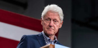 Bill Clinton speaking at podium.