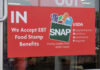 Red sign accepting EBT food stamp benefits SNAP