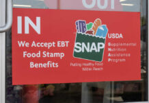 Red sign accepting EBT food stamp benefits SNAP