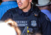 Secret Service officer in uniform with equipment visible.