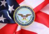 Department of Defense emblem on an American flag background