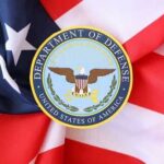 Department of Defense emblem on an American flag background