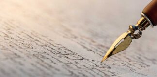 Close-up of a fountain pen writing on parchment paper