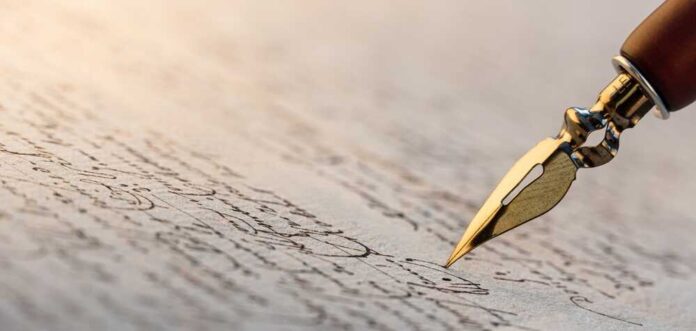 Close-up of a fountain pen writing on parchment paper