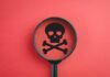 White Plague Returns — America Caught Napping Magnifying glass focusing on a skull and crossbones symbol against a red background