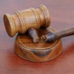 Court KILLS Biden Plan — Millions Face Payment SHOCK A wooden gavel resting on a circular base