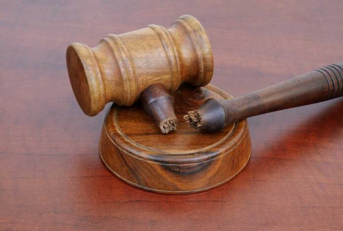 shutterstock_2603389759.jpg A wooden gavel resting on a circular base