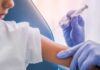 A healthcare professional administering a vaccine to a child's arm