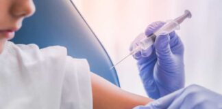 A healthcare professional administering a vaccine to a child's arm