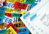 A collection of colorful vehicle registration stickers and DMV paperwork