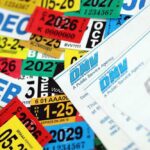 A collection of colorful vehicle registration stickers and DMV paperwork