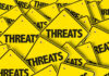 ALERT: Trump THREATENS Total Destruction Yellow signs with the word threats overlapping