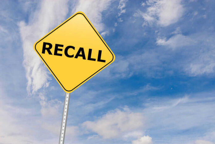 shutterstock_529192612.jpg Yellow sign with RECALL text against blue sky.