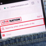 Mobile phone displaying the Live Nation website in a denim pocket