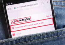 Mobile phone displaying the Live Nation website in a denim pocket