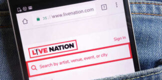 Mobile phone displaying the Live Nation website in a denim pocket