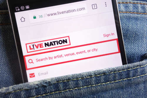 Mobile phone displaying the Live Nation website in a denim pocket