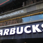 Signage for McDonald's and Starbucks in an urban setting