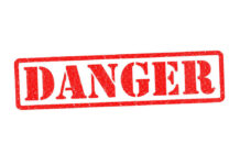 Red danger stamp on white background