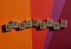 Wooden letter tiles spelling 'CRACKDOWN' on a colorful background