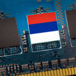 Close-up of a circuit board with a memory chip and a flag design