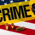Midnight Gunfire Leaves 7 Shot A gun and bullets on an American flag with a crime scene marker