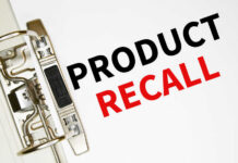 A binder clip holding a sheet of paper with the words 'PRODUCT RECALL' printed in bold letters