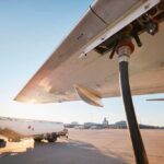 Fueling an aircraft at the airport with a hose connected to the wing