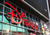 Disney sign on building with Mickey Mouse figure