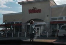A person walking outside a Wawa convenience store
