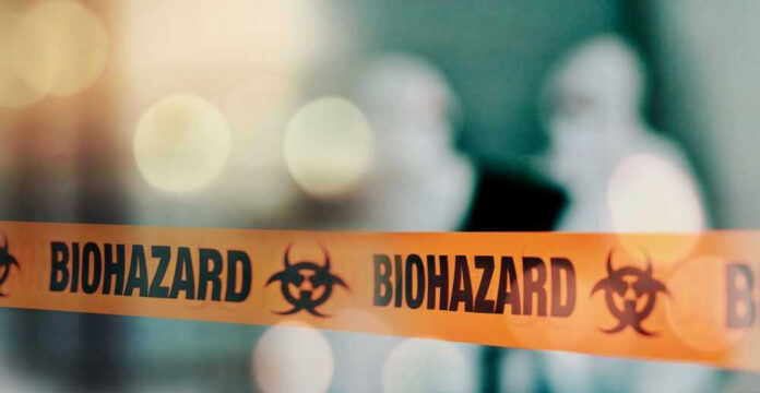 Biohazard tape with blurred figures in background.