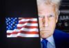 Close-up of a political figure with an American flag in the background