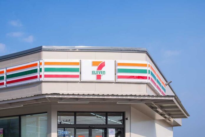 Exterior view of a 7-Eleven convenience store under a clear blue sky