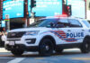 Emergency Curfew Sparks Controversy Police SUV with lights on in an urban environment