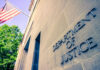 Capitol Cops Fight Back: $1.8B DOJ Fund Blocked? Department of Justice building with American flag.