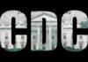 Deadly Cruise-Ship Virus Sparks CDC Pushback Artistic representation of the letters CDC overlaid on a dollar bill featuring a government building