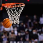 A basketball is about to enter the hoop during a game