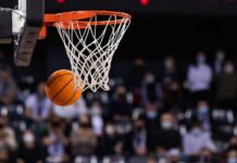 A basketball is about to enter the hoop during a game