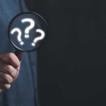 Shocking Fatalities in California — Truth Still Unknown Hand holding magnifying glass with question marks.