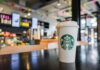 Starbucks Axing: More Jobs Vanish! Coffee cup on table in cafe interior