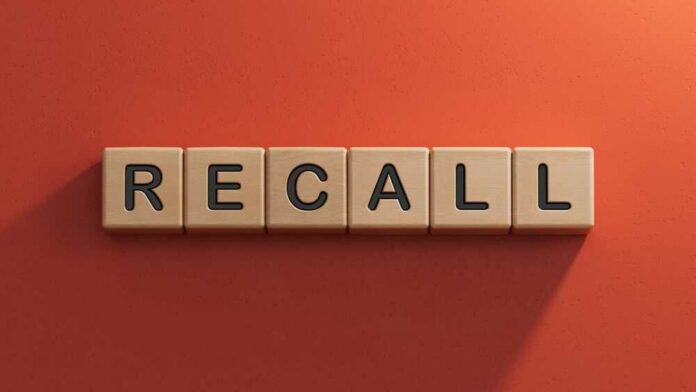 The word 'RECALL' displayed in wooden letter blocks against a red background