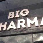 Amazon Just DESTROYED Big Pharma’s Pricing Model Sign displaying the words BIG PHARMA on a glass building
