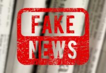 Red stamp with the words 'FAKE NEWS' over blurred newspaper background