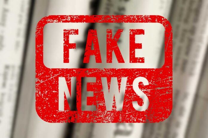 shutterstock_2635871793.jpg Red stamp with the words 'FAKE NEWS' over blurred newspaper background