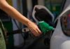 Iran Chokepoint Chaos Hits U.S. Pumps Hard Person refueling a car at a gas station