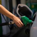 Iran Chokepoint Chaos Hits U.S. Pumps Hard Person refueling a car at a gas station