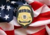 ICE Agent Indicted — Perjury Probe Launched ICE officer badge placed on an American flag