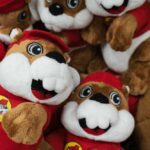 A collection of plush toys resembling a cartoon character, wearing red outfits